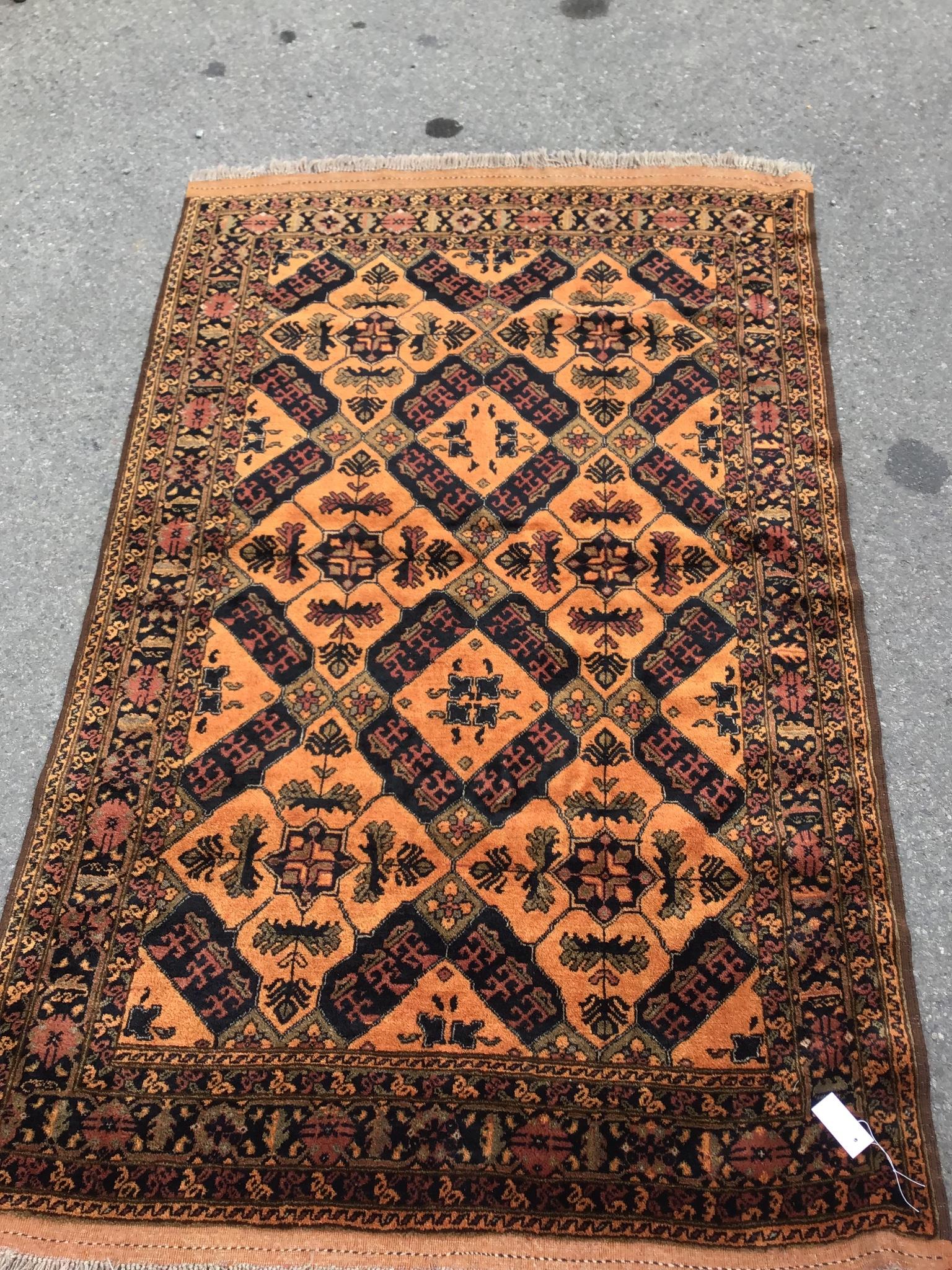 An Afghan gold ground rug, 186 x 124cm